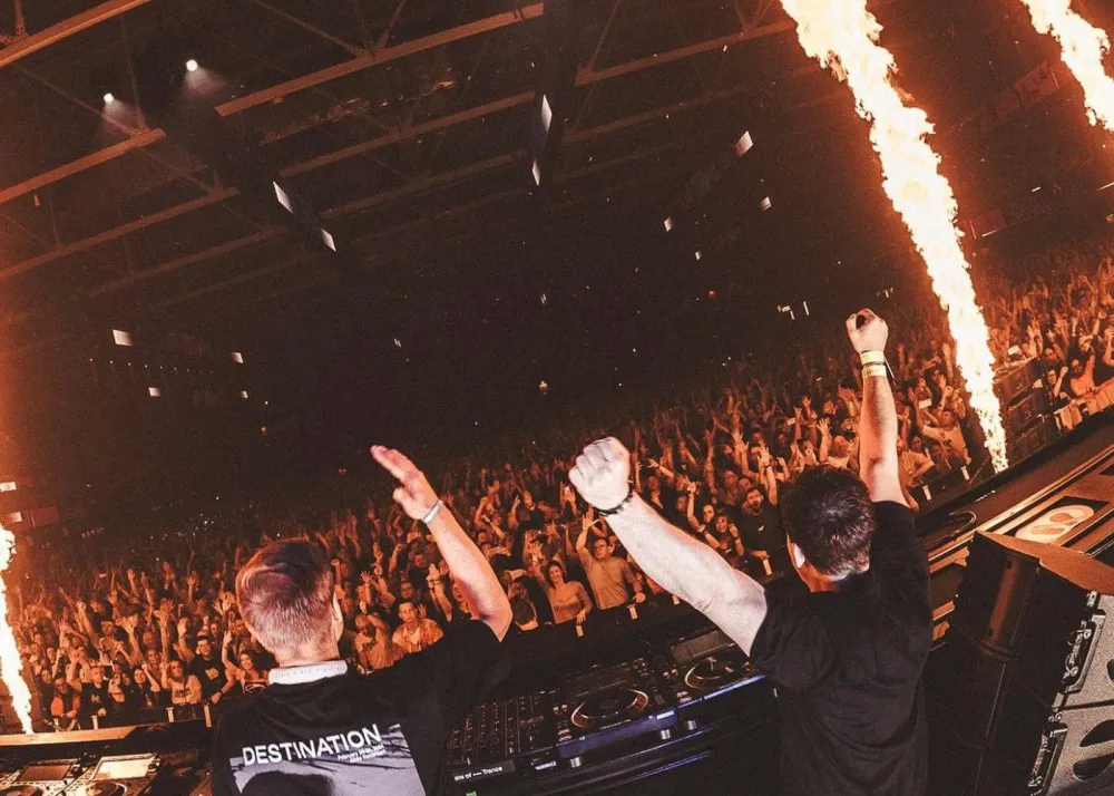 armin van buuren performing with another dj on stage with sparklers and crowd in background, hong kong creamfields 2024 headliners