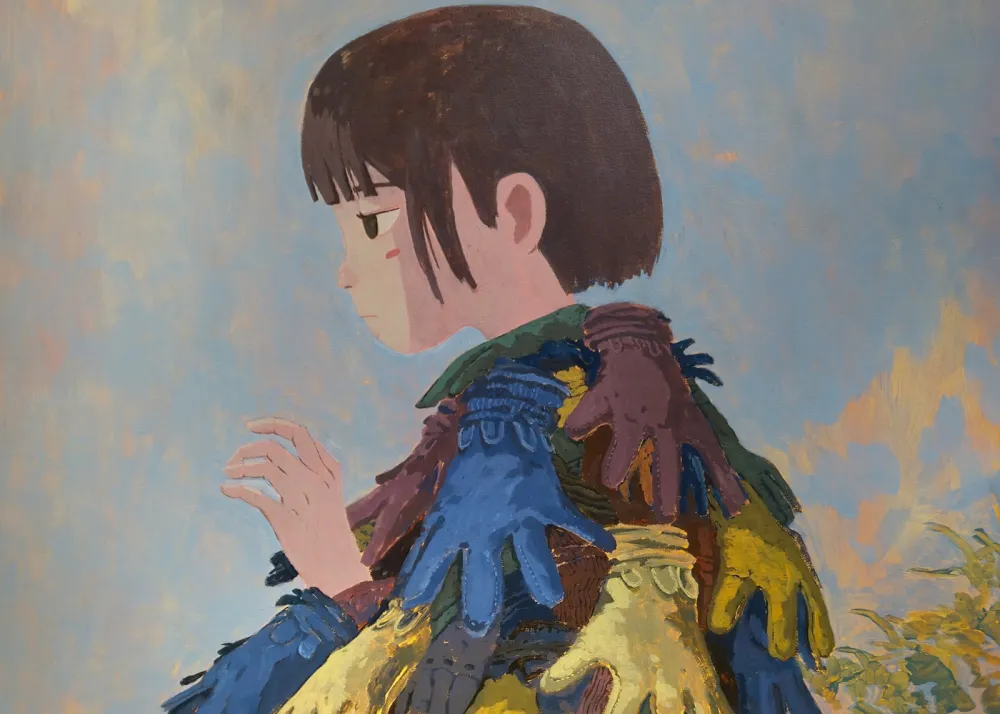 A person looking to the left with a shirt full of gloves