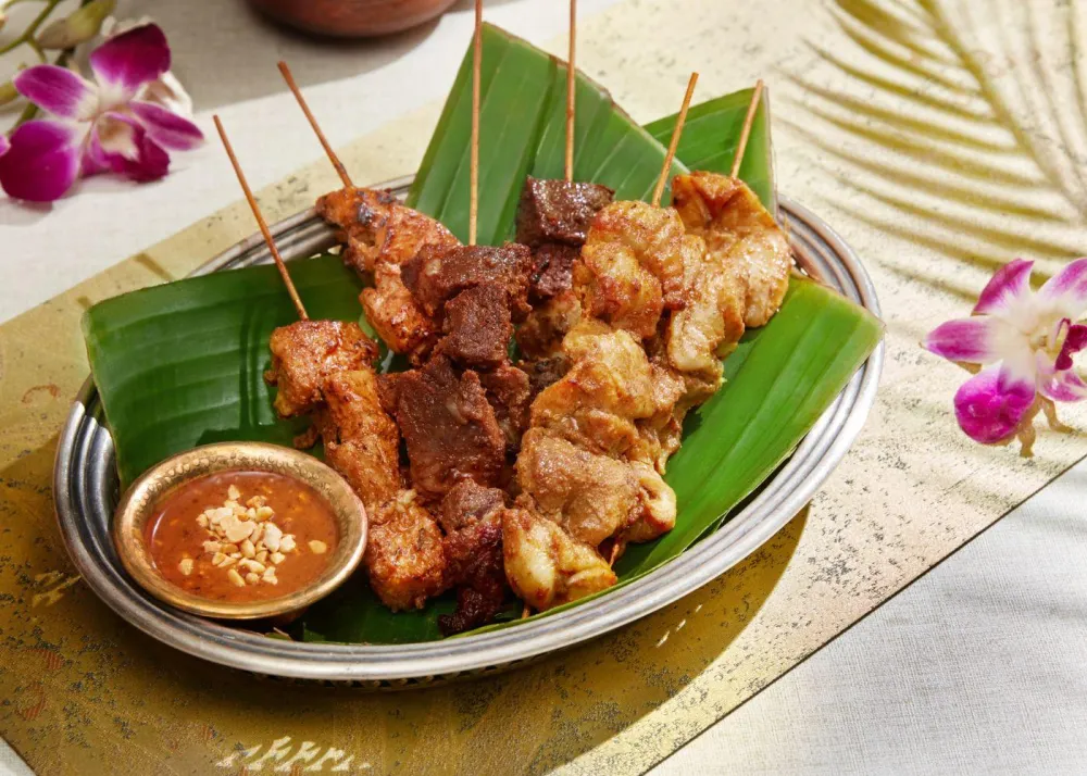 Charcoal-grilled pork neck salad, chicken and beef satay skewers