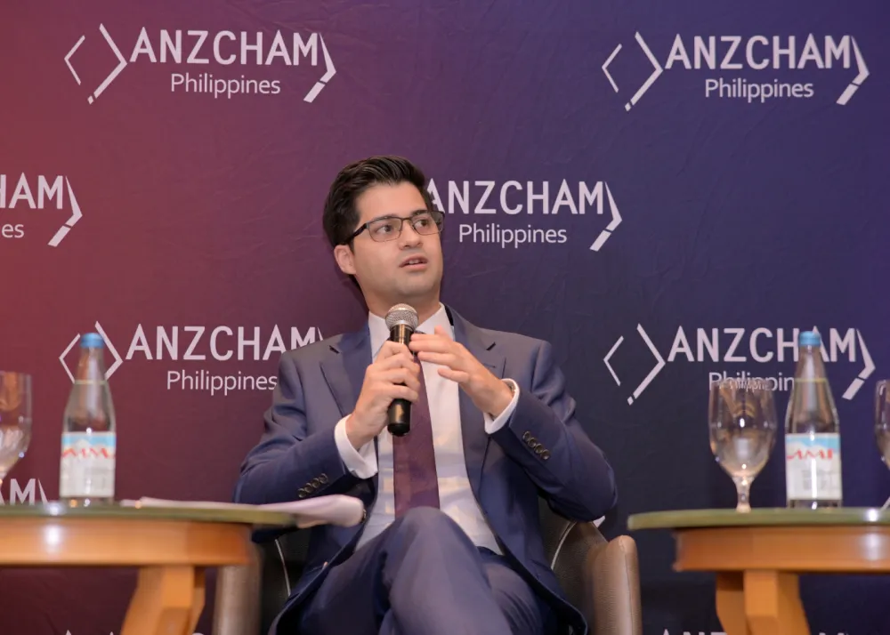 A man speaking with a microphone