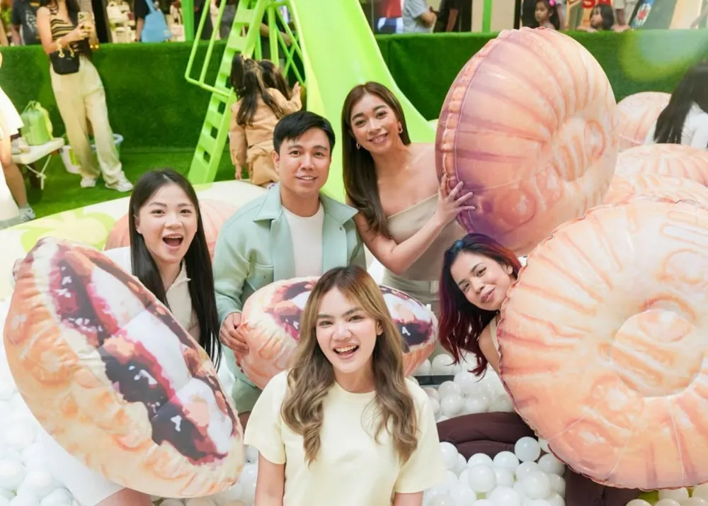 People in a ball pit with brioche bun floaters