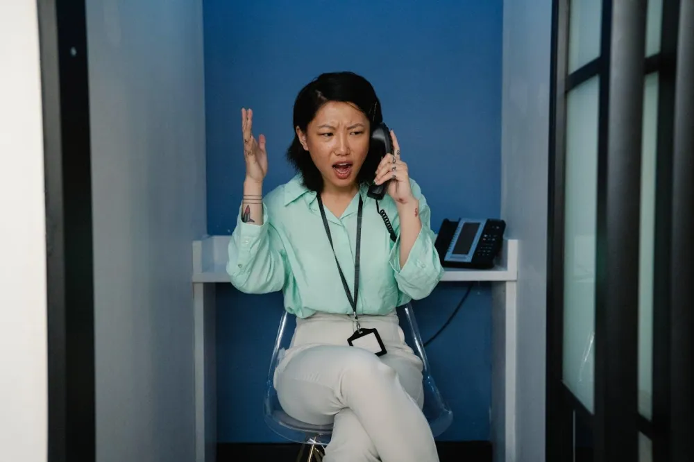 Woman in Long Sleeves Talking on the Phone