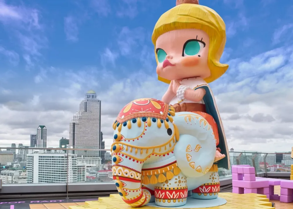 A MOLLY figurine sitting on an elephant with Thai elements