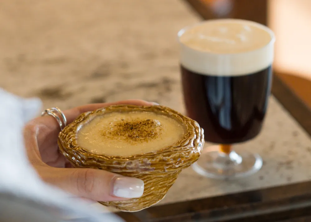 A coffee egg tart with a glass of coffee