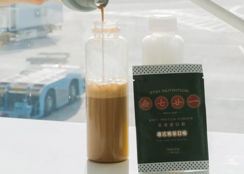 A protein shake with a protein sachet on the side