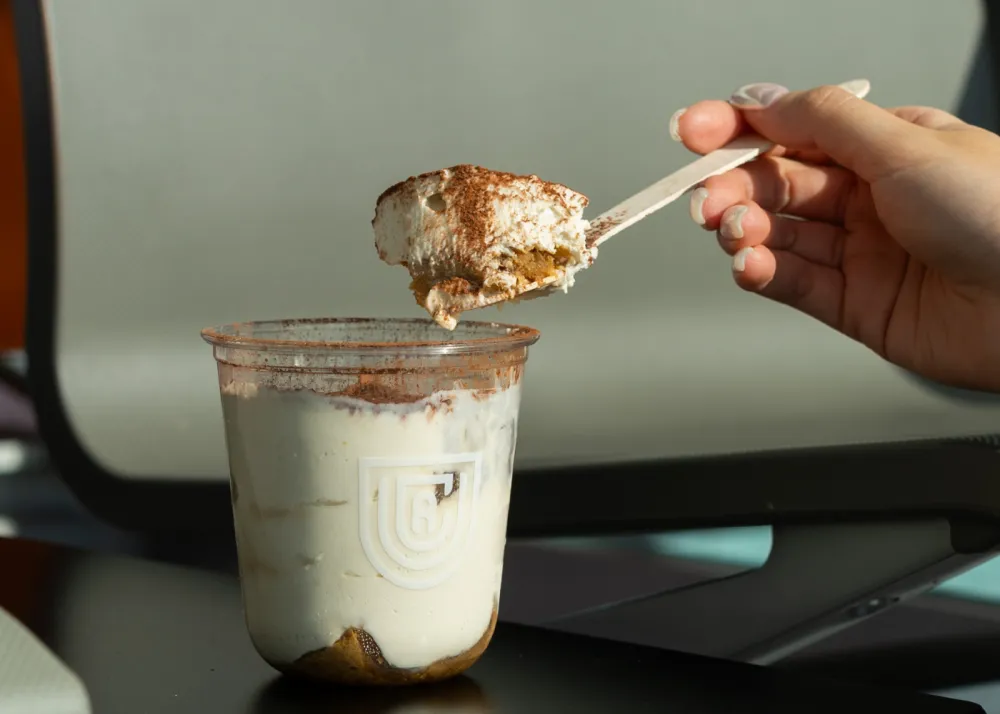 A tiramisu in a plastic cup