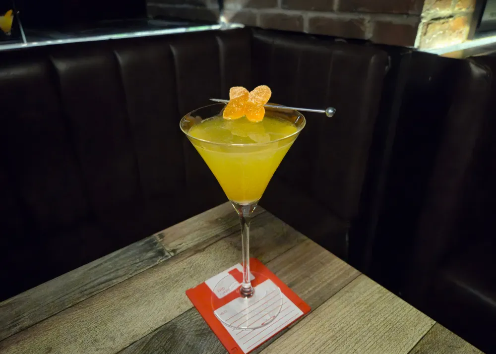 A cocktail with sweet orange slices as garnish