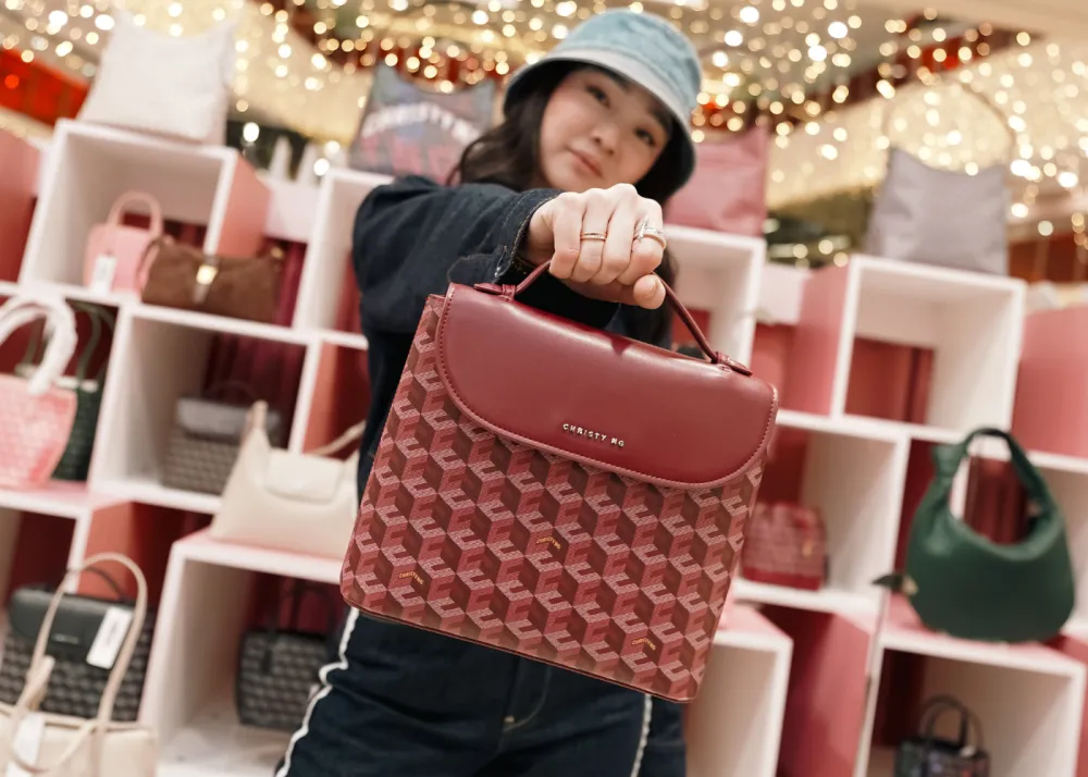 A photo of Christy Ng with the Julio Backpack in Burgundy