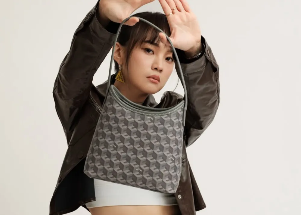 A photo of Christy Ng showcasing the new colorways of her bags