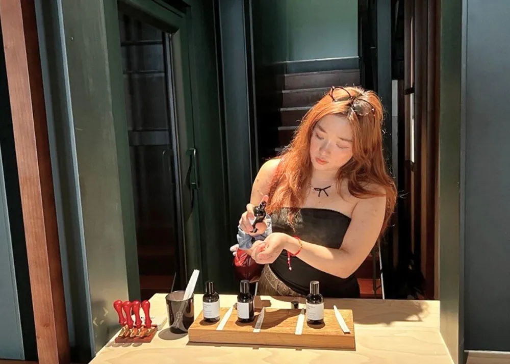 Woman trying on perfume at Perfumer H Shanghai flagship in French Concession as photographed by The Beat Asia