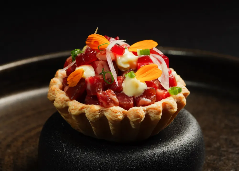 The beef tartare on top of a crumbly pastry cup
