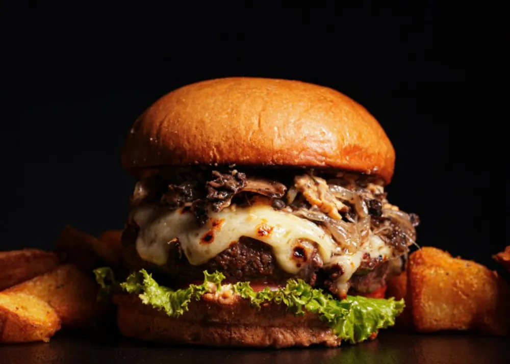 A truffle burger with a brioche bun and truffle flavors