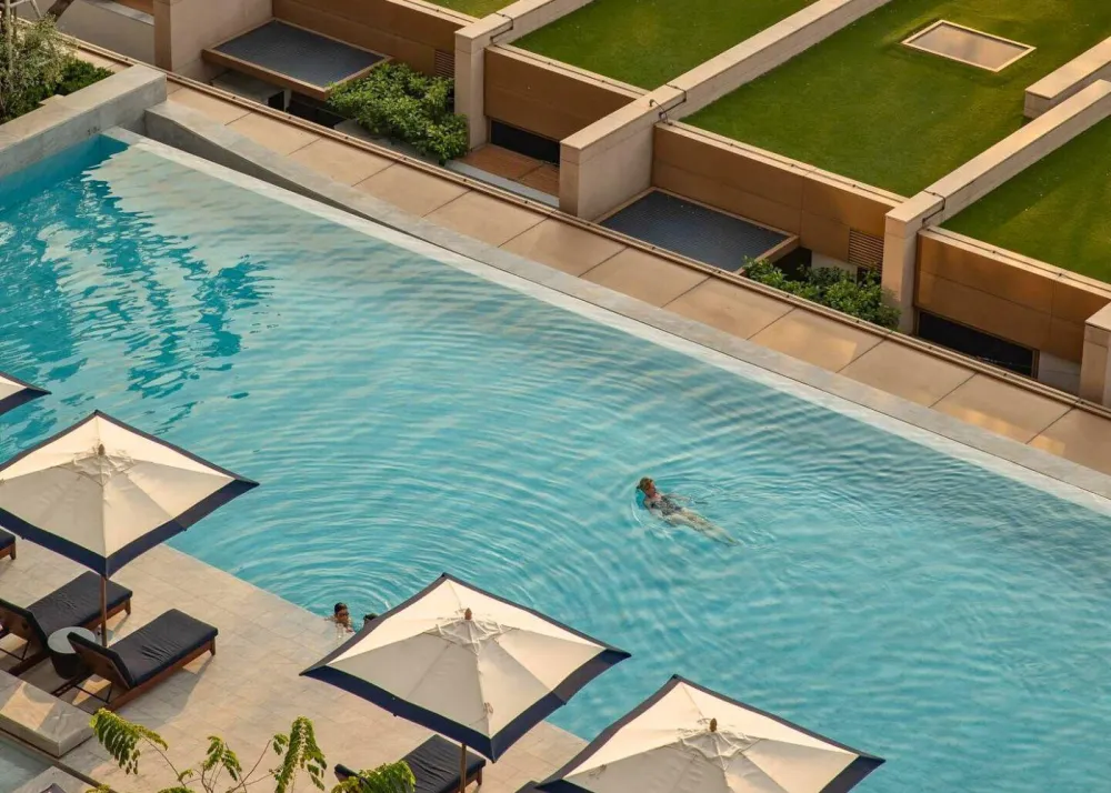 Woman swimming in Capella Bangkok's outdoor pool
