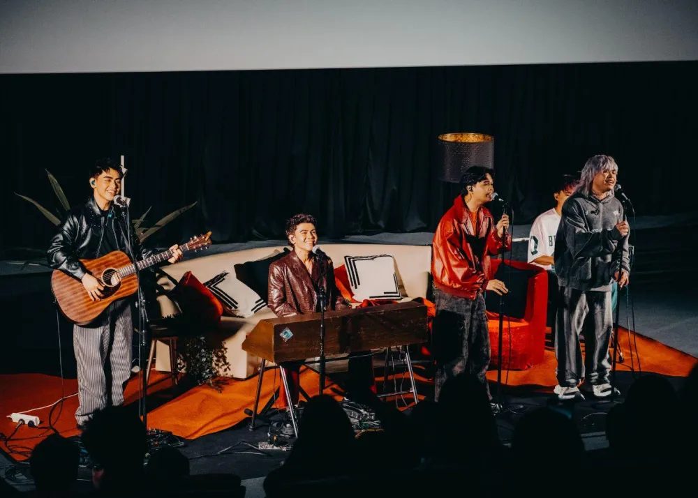 The Juans performs for fans during the listening party for TAWID