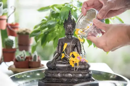 pouring water on buddha