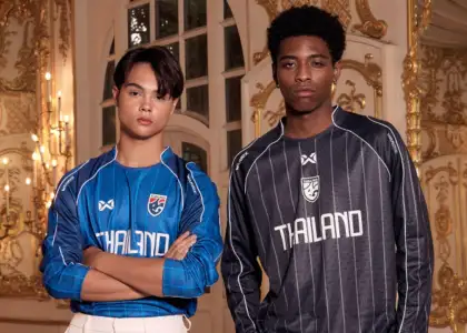 Two male models sporting Warrix football tops