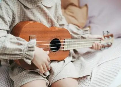 Kid playing ukelele