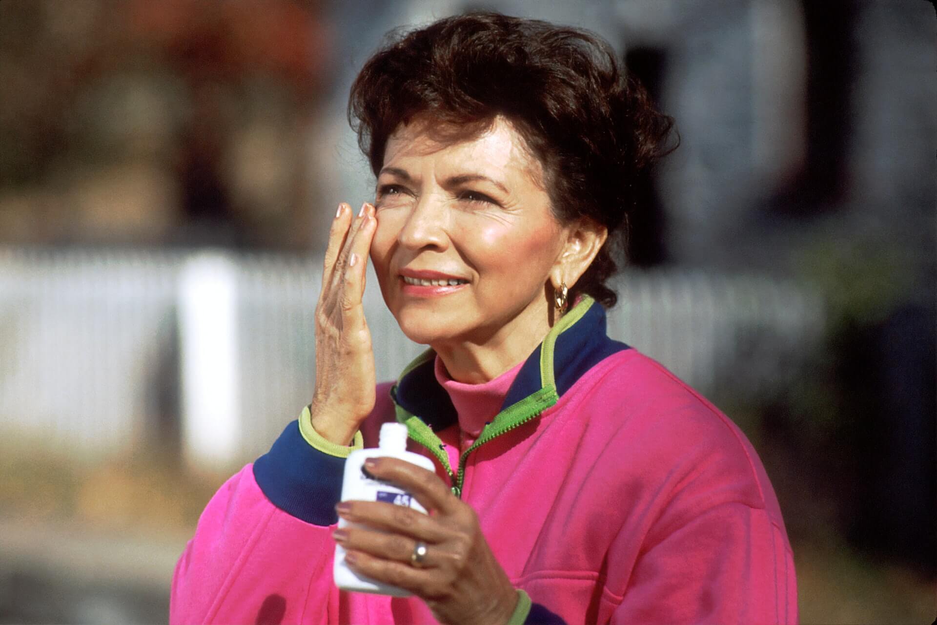 Woman applying sunscreen