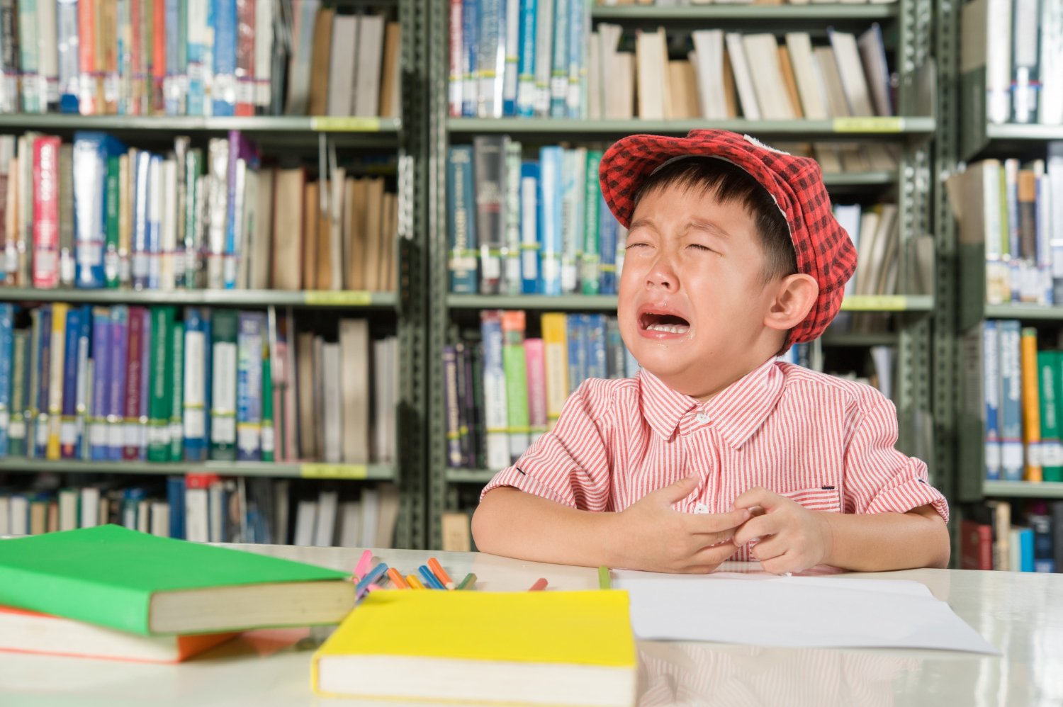 crying boy in the library