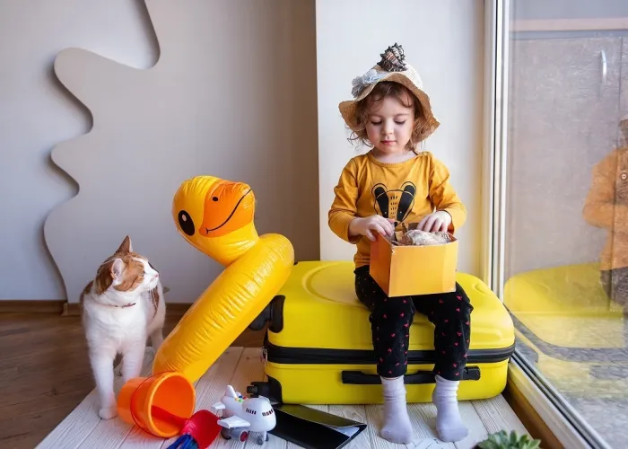 A little girl and red cat packed things in luggage 2021 09 02 14 42 01 utc