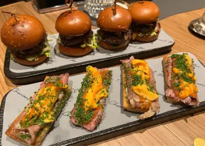 uni toast and mini burger on top of a tray at charcoal bar hong kong