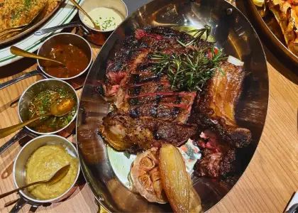 sauces next to a grilled steak served on a platter at charcoal bar hong kong