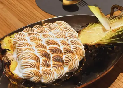 flambe cream served in a pineapple on a platter at charcoal bar hong kong