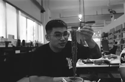 man eating noodles
