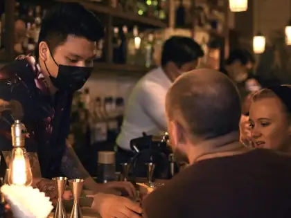 man serving bar guests
