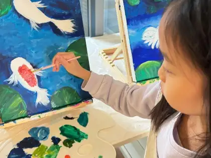 child painting fish