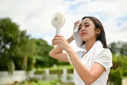 girl using a portable handy fan