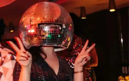 Female with disco ball on her head