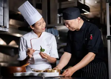 chef monnipa rungthong in kitchen with sous chef