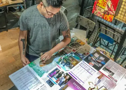 ernest chang hong kong artist in studio painting over collage