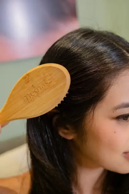 The treatment starts with a wooden brush scalp massage
