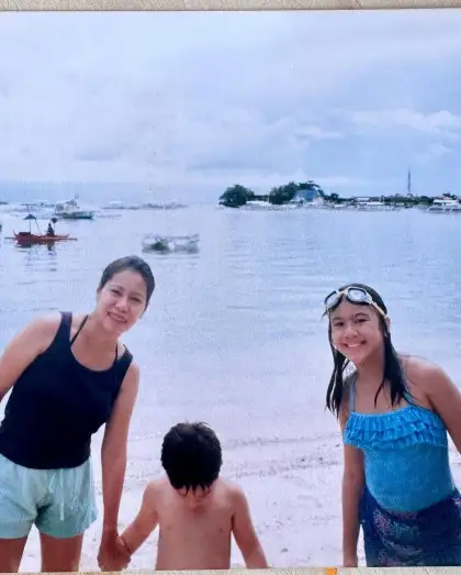 A young Nina with her mother and brother