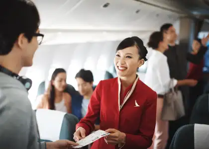 Cathay Pacific flight attendant greets passenger