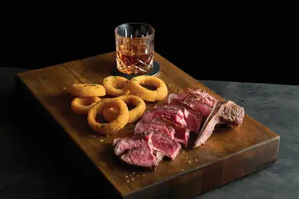 streak with onion ring and cocktail