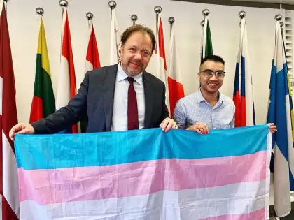 With the transgender flag