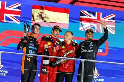 Lando Norris (Left), Carlos Sainz (Middle-Left), and Lewis Hamilton (Right) celebrating their podium placement at the 2023 Singapore Grand Prix.