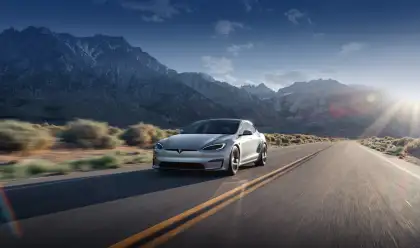 A silver Tesla Model S driving