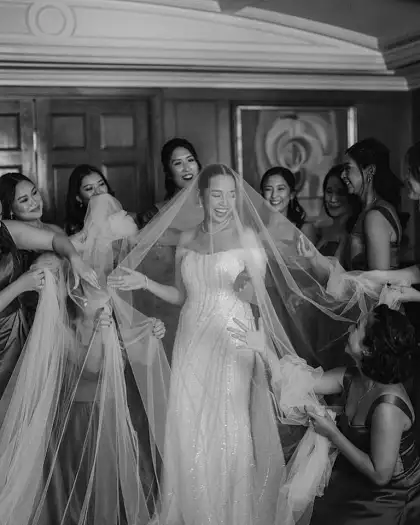 A bride celebrates in her Andrea Tetangco gown