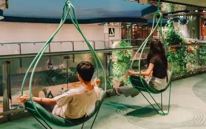 The green swinging pendulum chairs give travelers a moment to relax