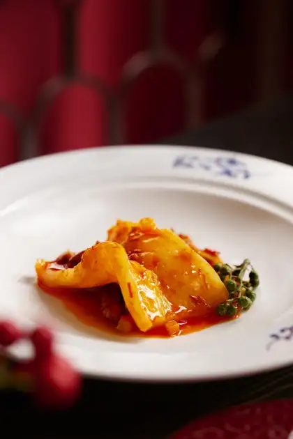 The dish showcases Chef Peng's exceptional dry-frying technique.