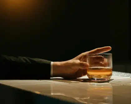 A man holding a whiskey glass.