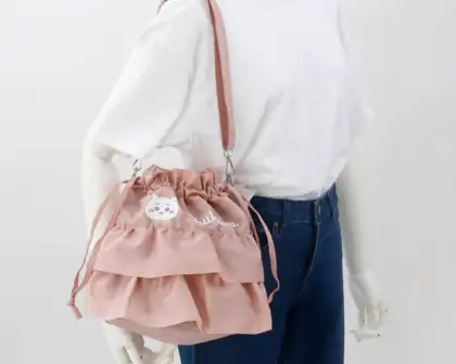 A small, ruffled shoulder bag