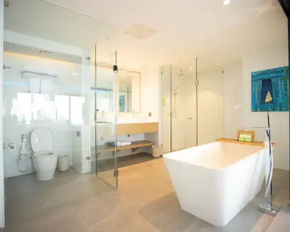 The bathroom in the Premium King Bayview Suite includes a standalone tub