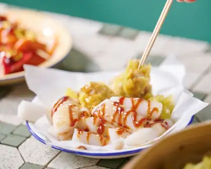 The Cheung Fun (Rice Noodle Rolls) is drizzled with sweet soy sauce, hoi sin sauce, and sesame seeds.