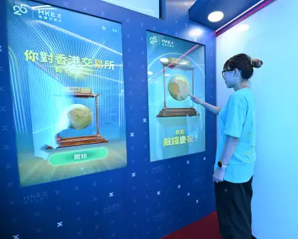 A person playing the interactive game in the Gongmobile