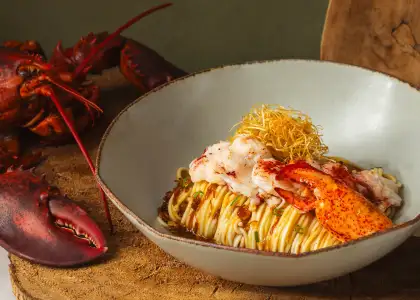 The Premium Lobster Dry Noodle in Chef's Seafood Sauce is an aromatic noodle dish completed with housemade seafood sauce and a fragrant shredded scallop mixture.